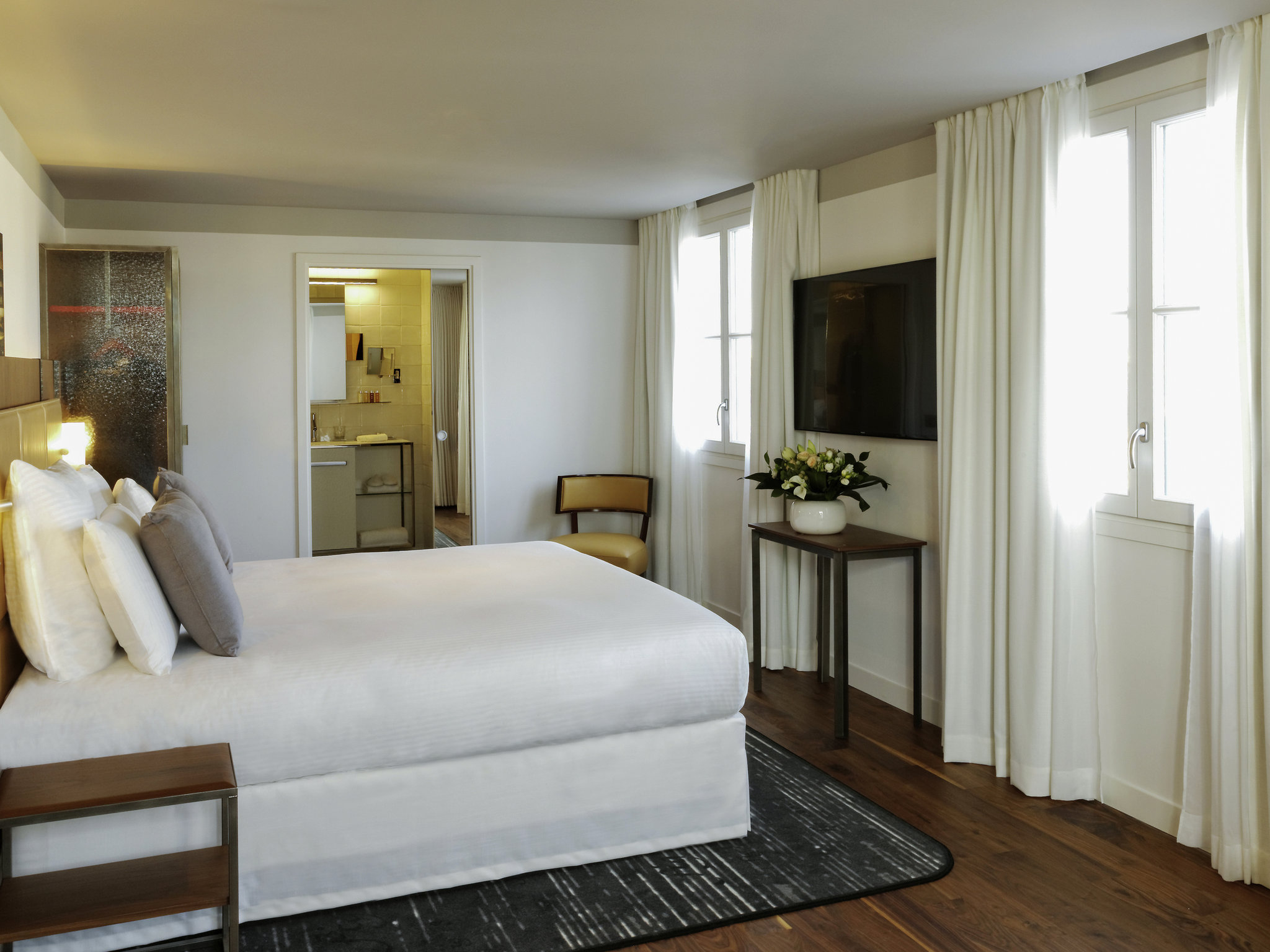 a bedroom with a bed and a tv
