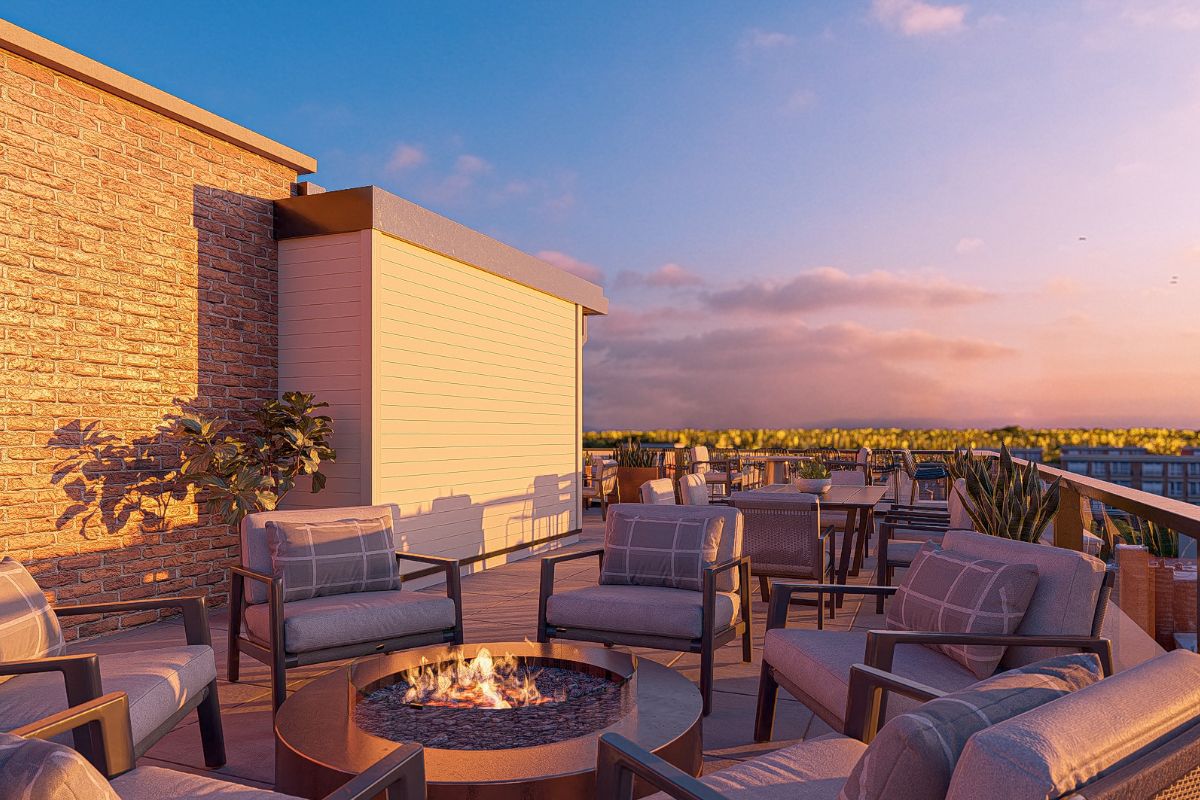 a patio with chairs and a fire pit