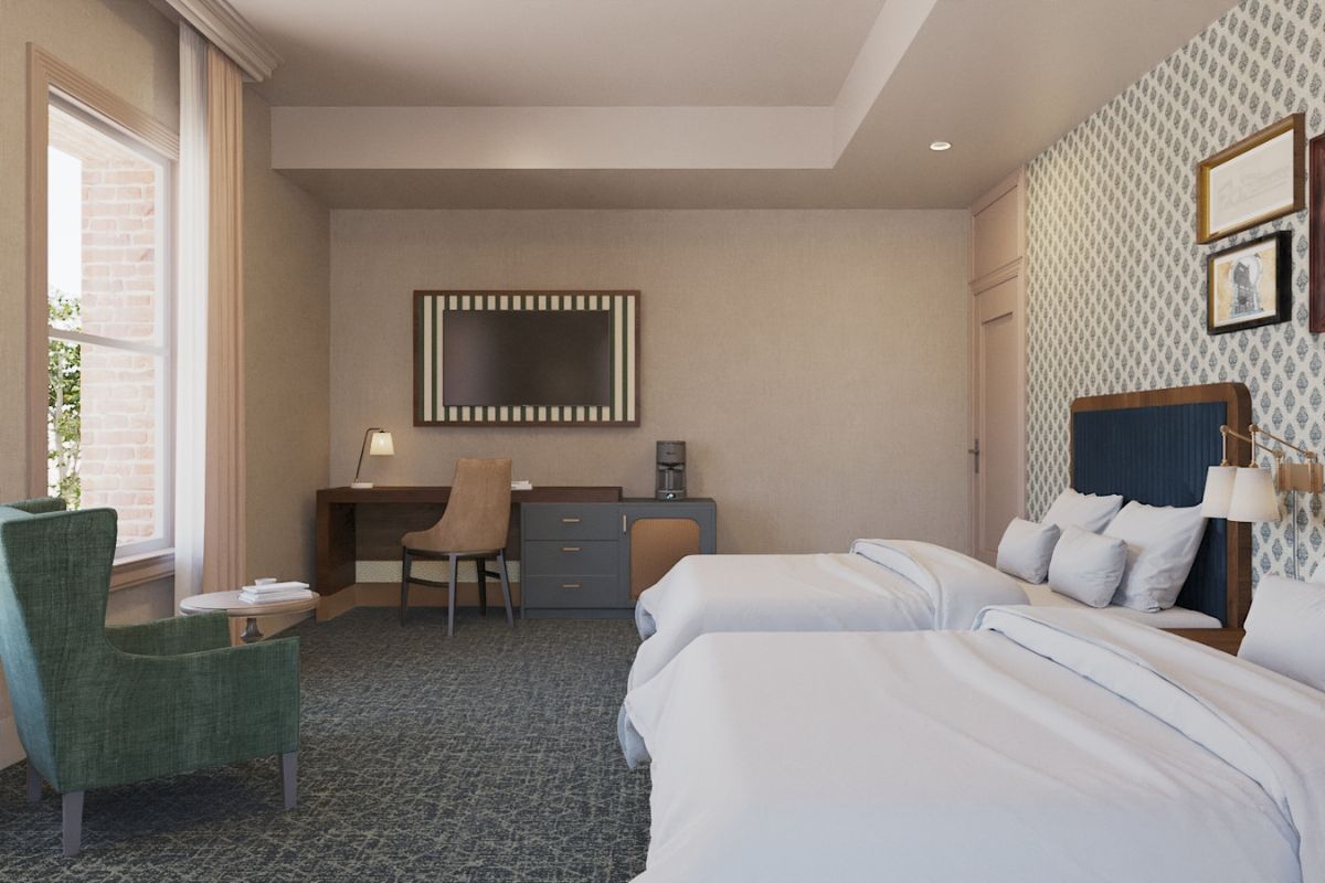 a room with two beds and a chair
