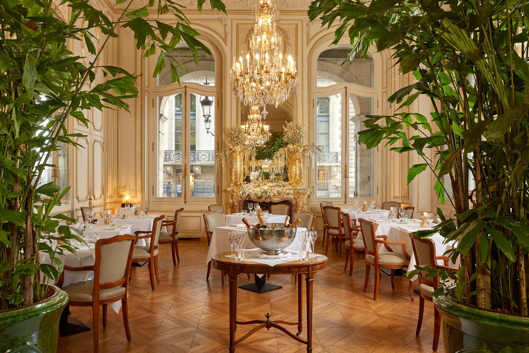 a room with tables and chairs and a chandelier