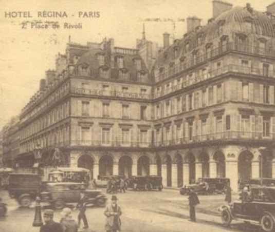 a building with many windows and cars on the street