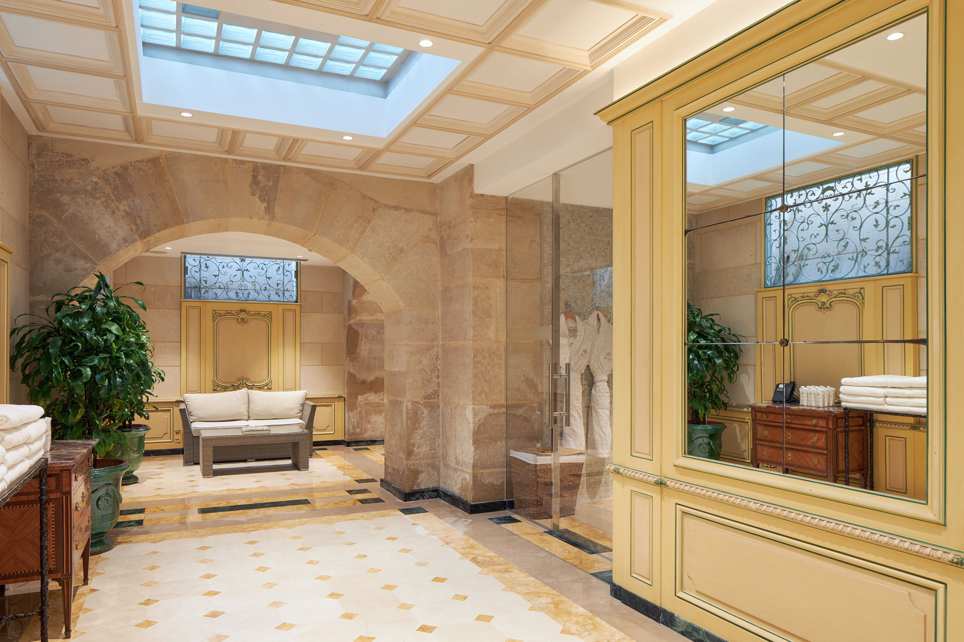 a room with a glass wall and a bench