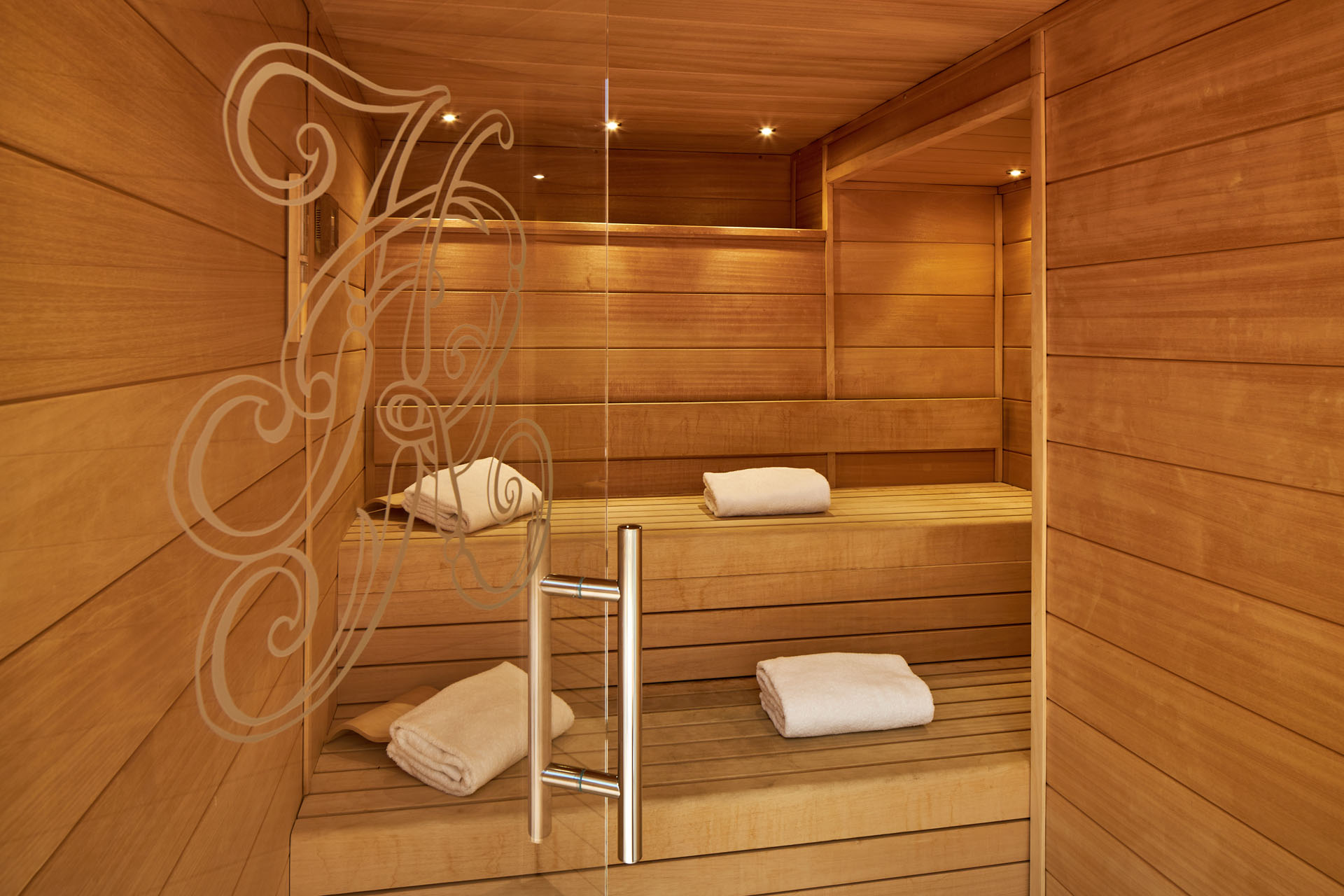 a sauna with towels on the shelves