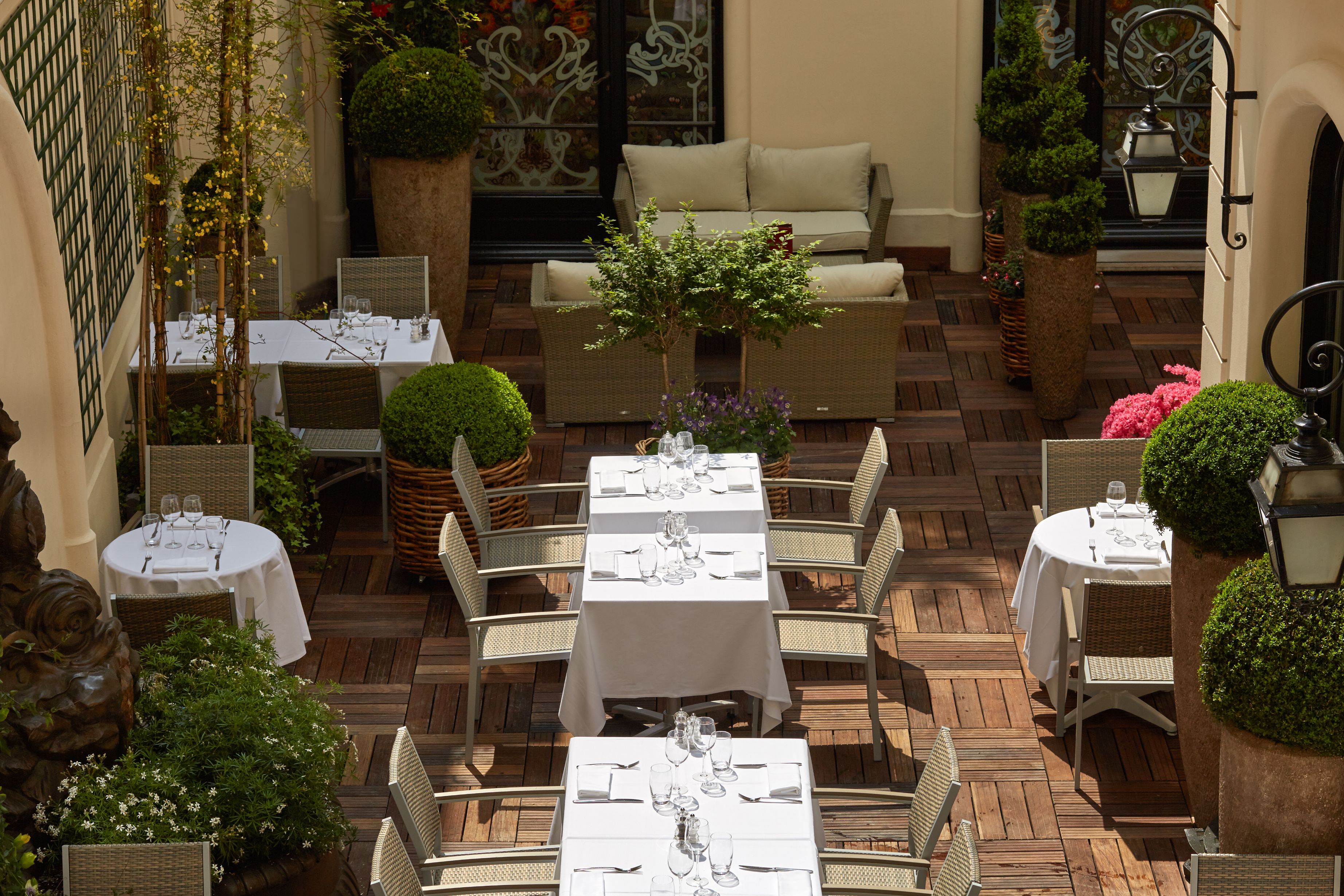 a patio with tables and chairs
