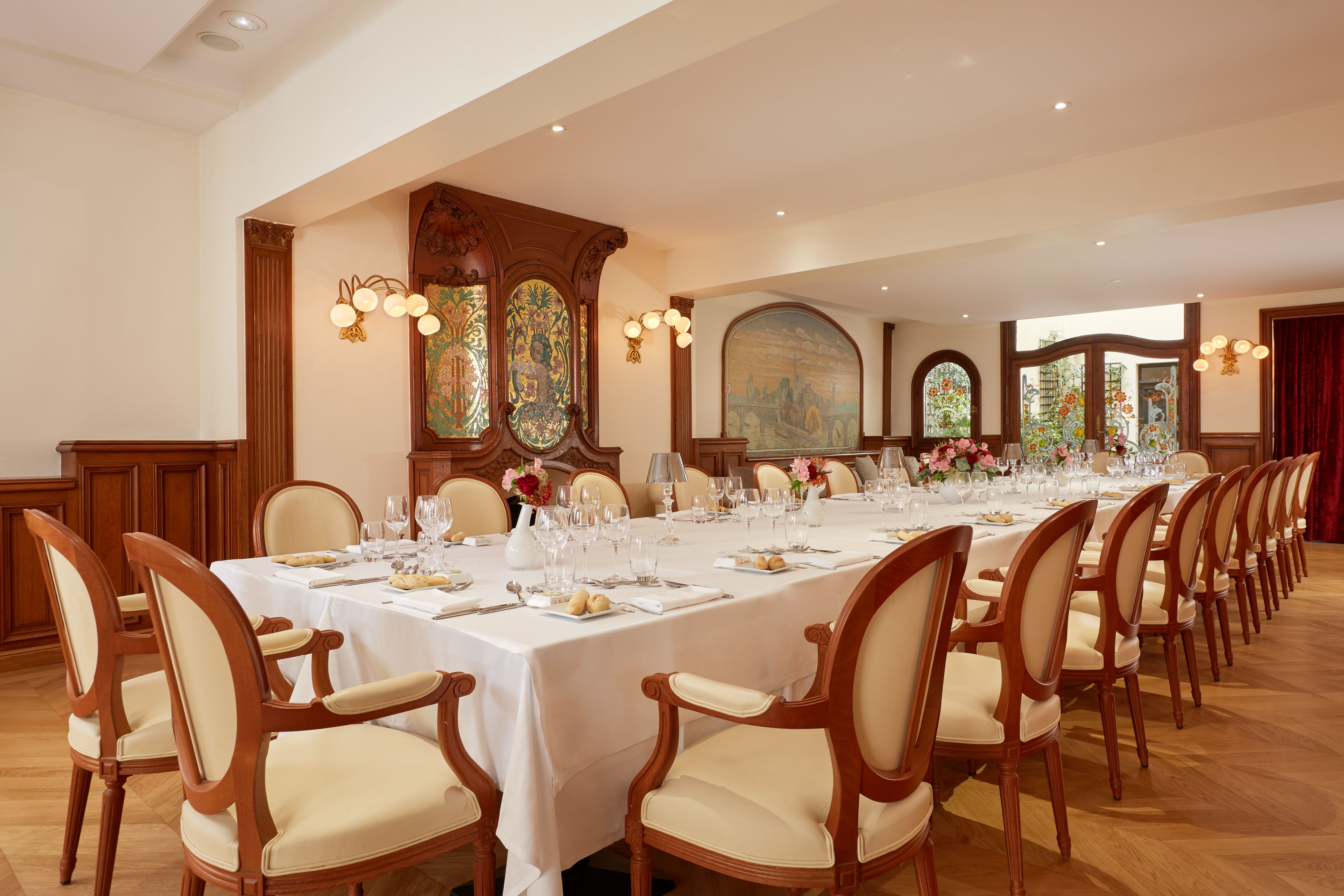 a large dining room with white tablecloths and chairs