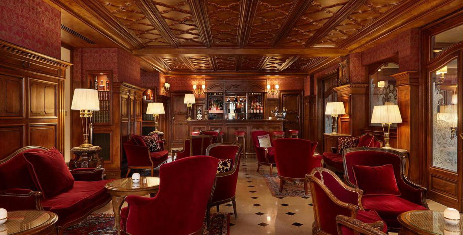 a room with red chairs and a bar