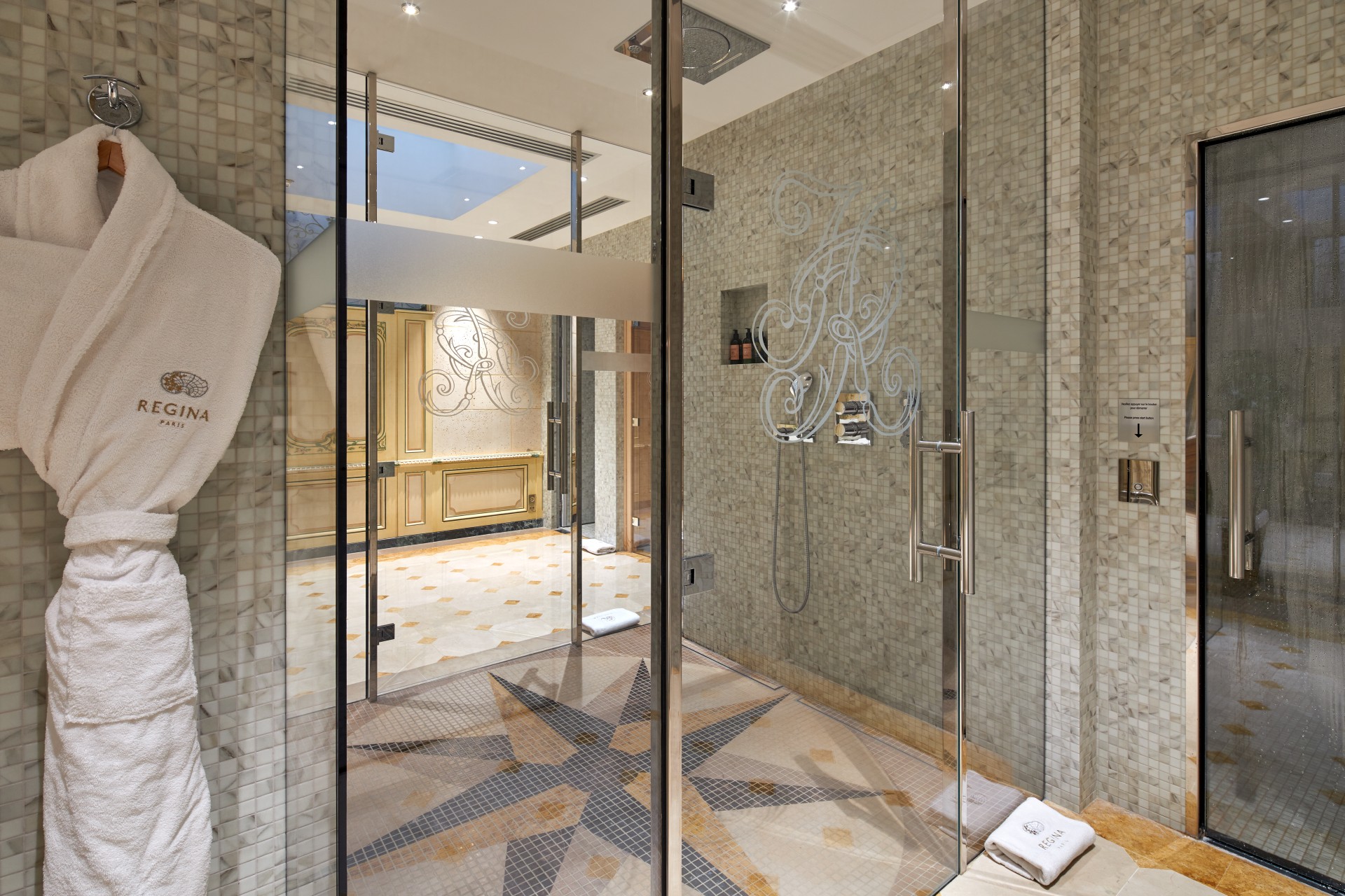 a glass shower with a star design on the floor