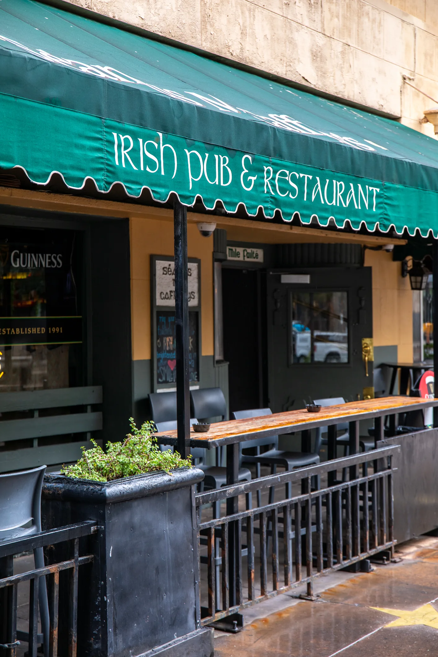 a restaurant with a green awning