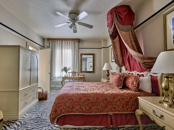 a bedroom with a bed and a ceiling fan