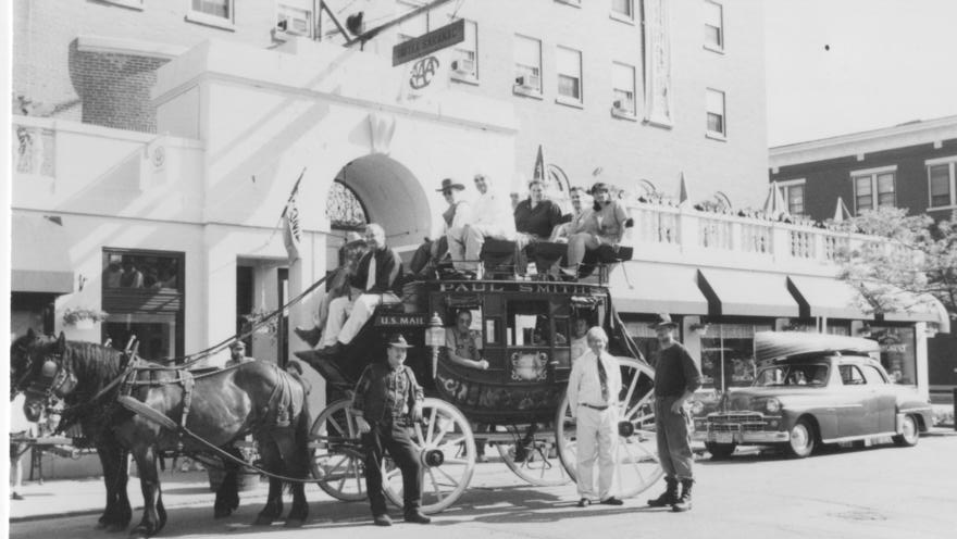 a horse drawn carriage with people on it