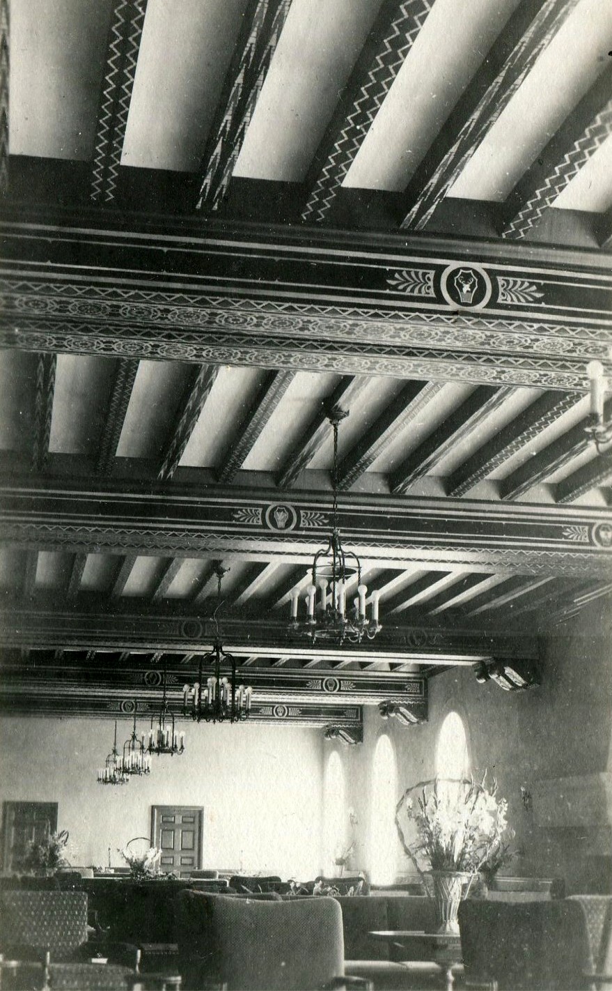 a ceiling with a chandelier and a window
