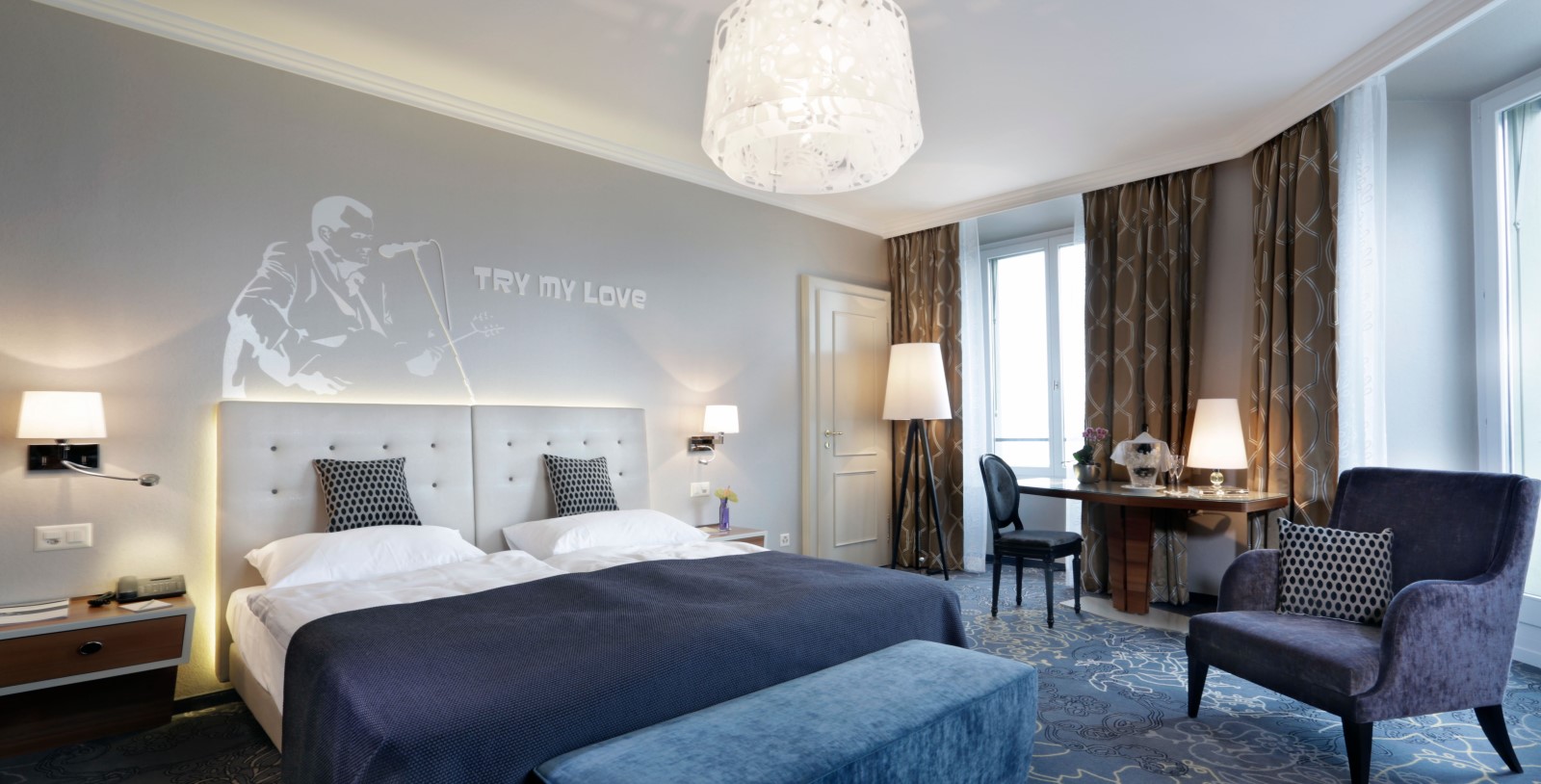 a bedroom with a desk and a bed