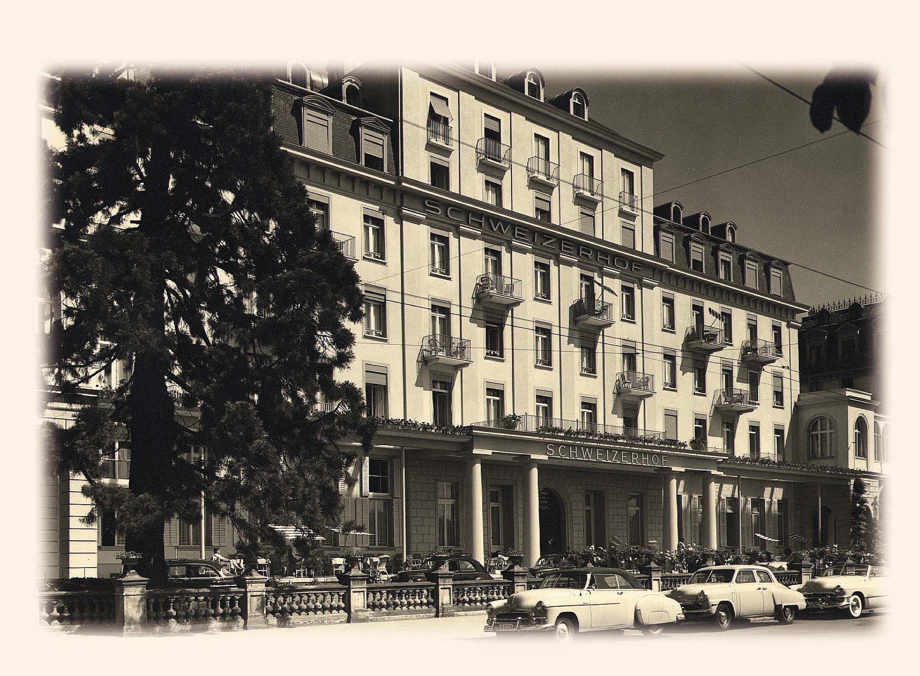 a building with many windows and cars parked on the side