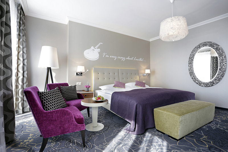 a bedroom with purple and black furniture