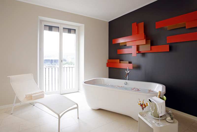 a bathroom with a tub and a chair