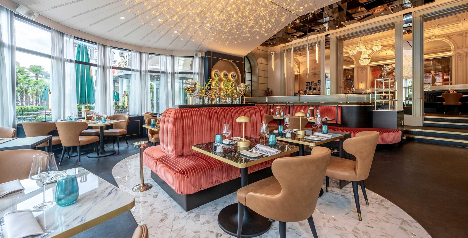 a restaurant with a chandelier and tables