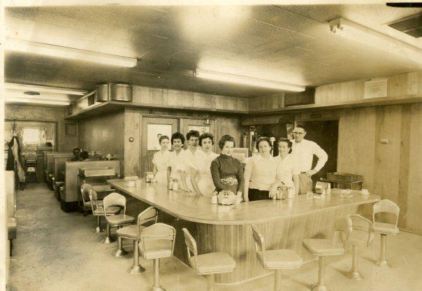 a group of people standing behind a counter