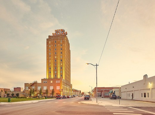 a street with cars and a tall building