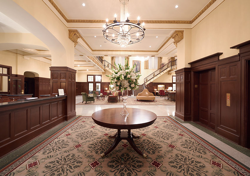 a lobby with a chandelier and a table