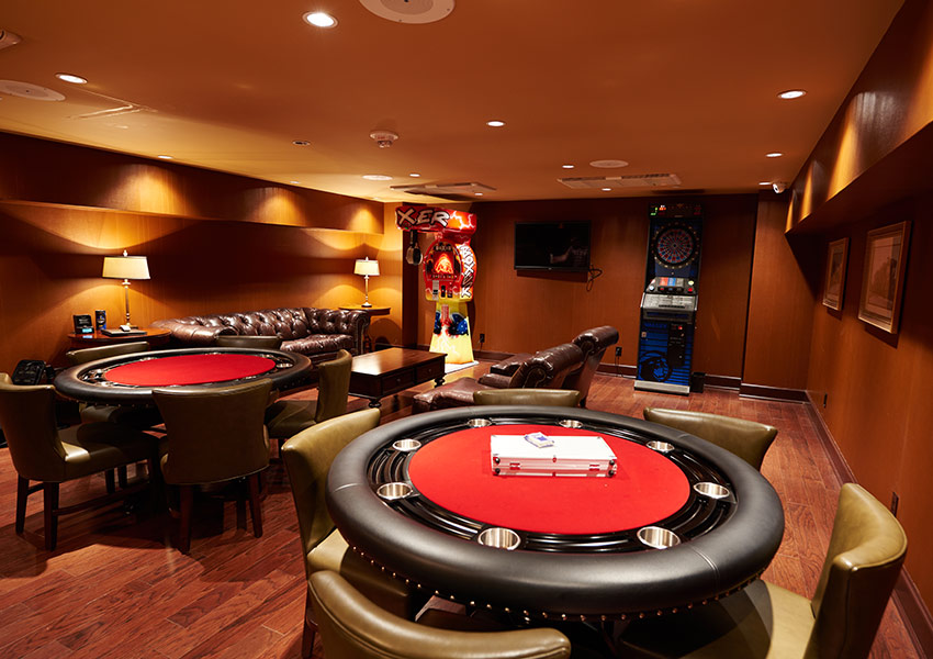a room with a poker table and a game machine