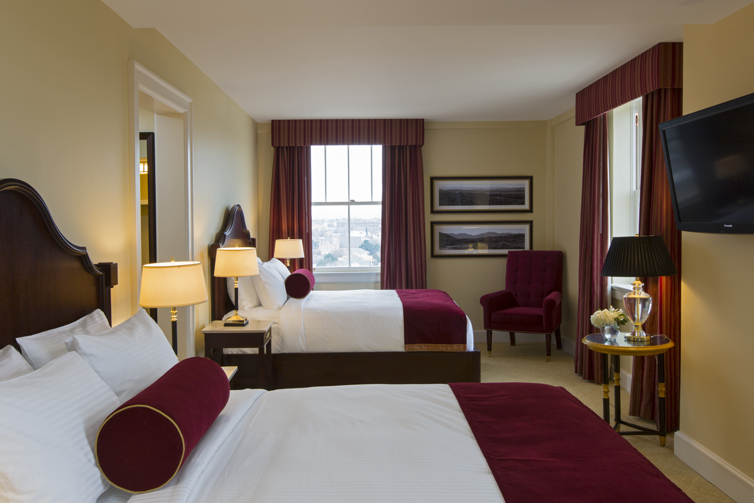 a room with two beds and a lamp