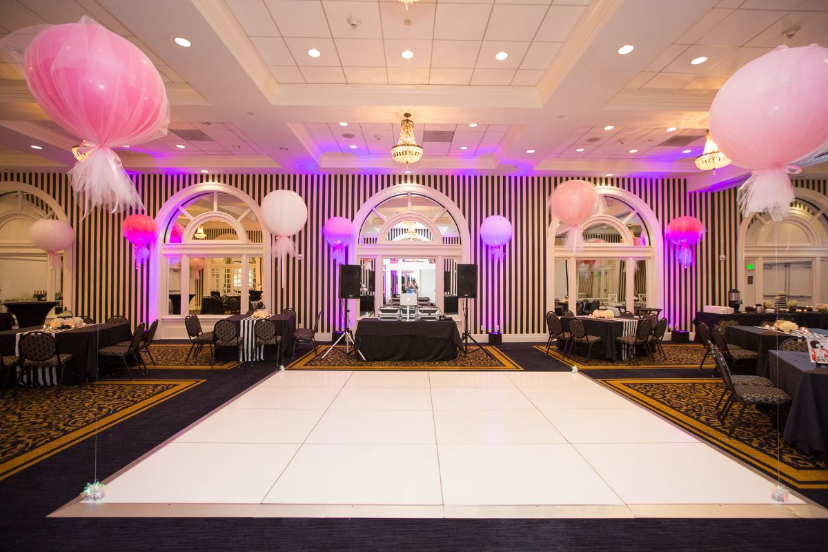 a room with a dance floor and balloons