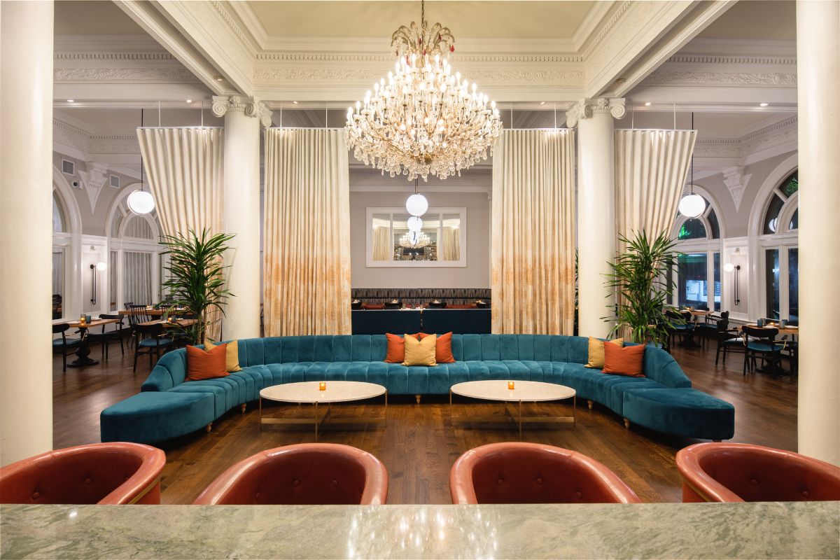 a large room with a large couch and chandelier