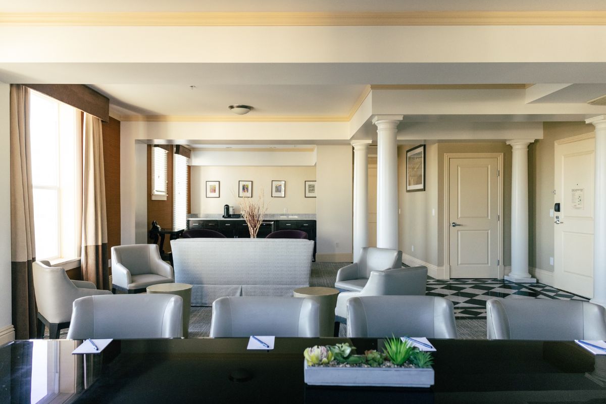a room with a black table and chairs