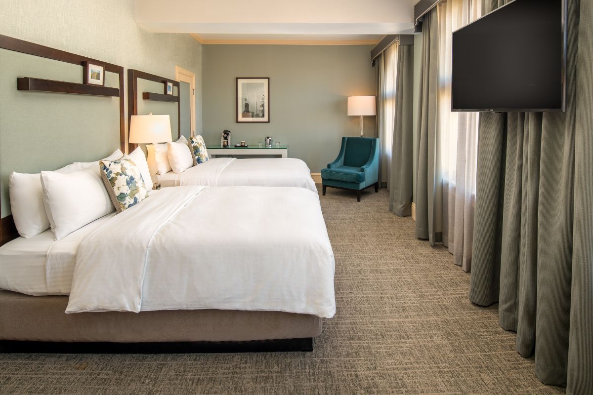 a hotel room with two beds and a television