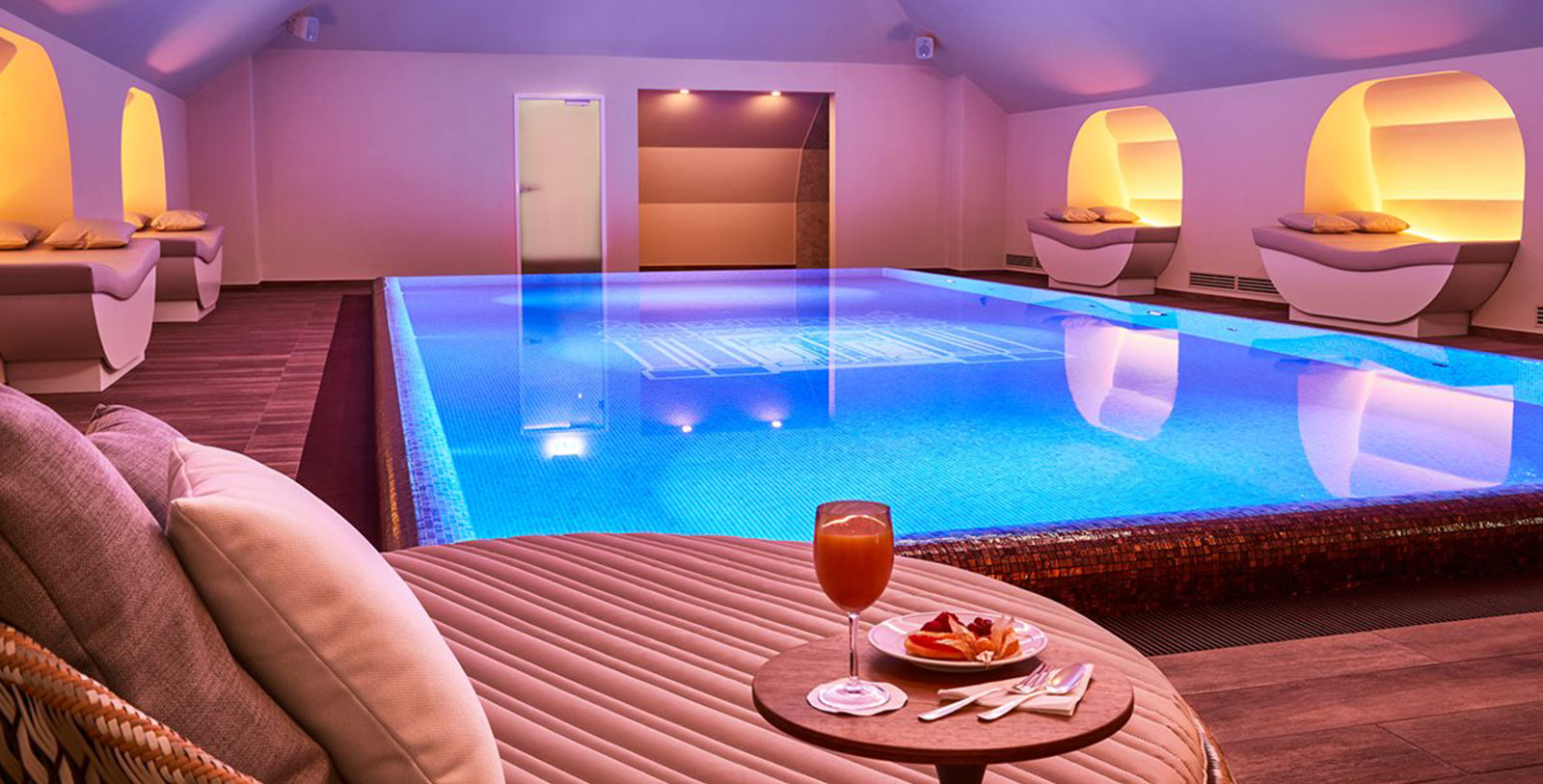a pool with a glass of juice and a plate of food