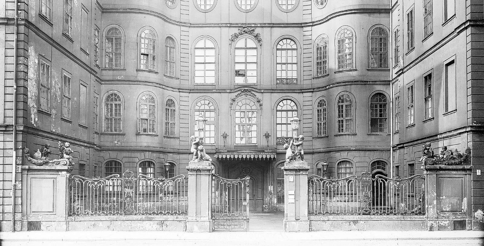 a building with a gate and statues