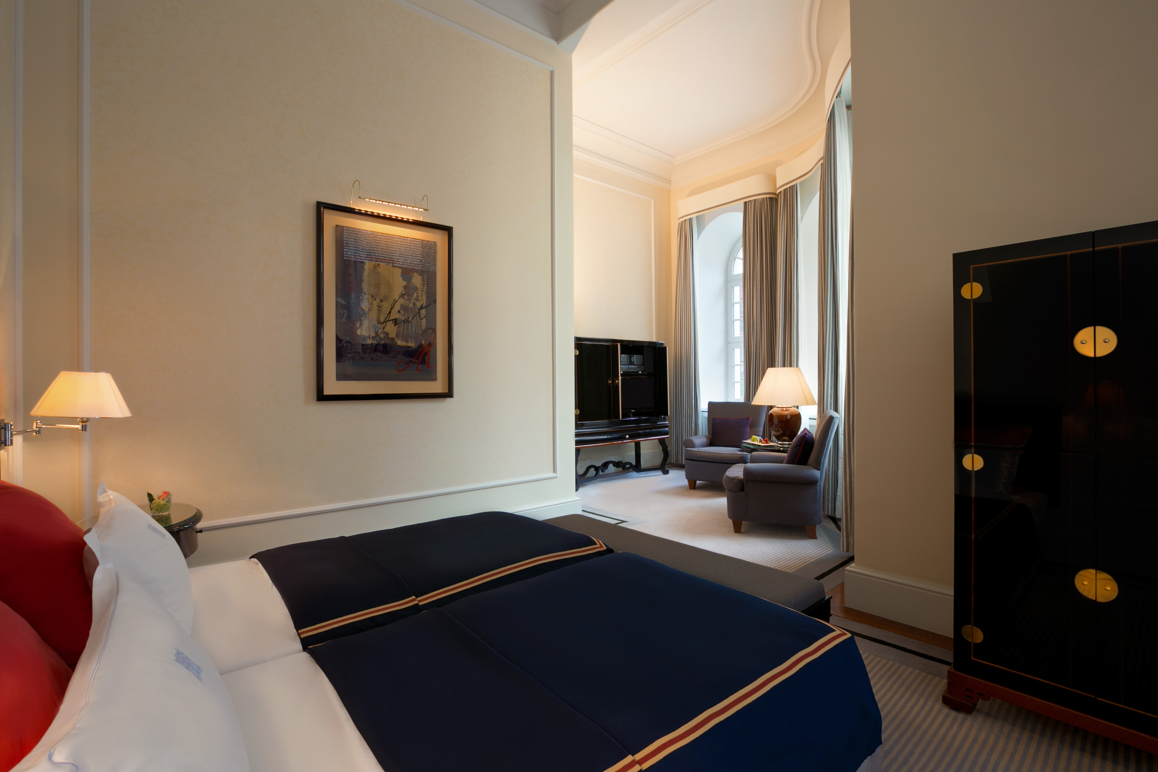 a room with a bed and a television