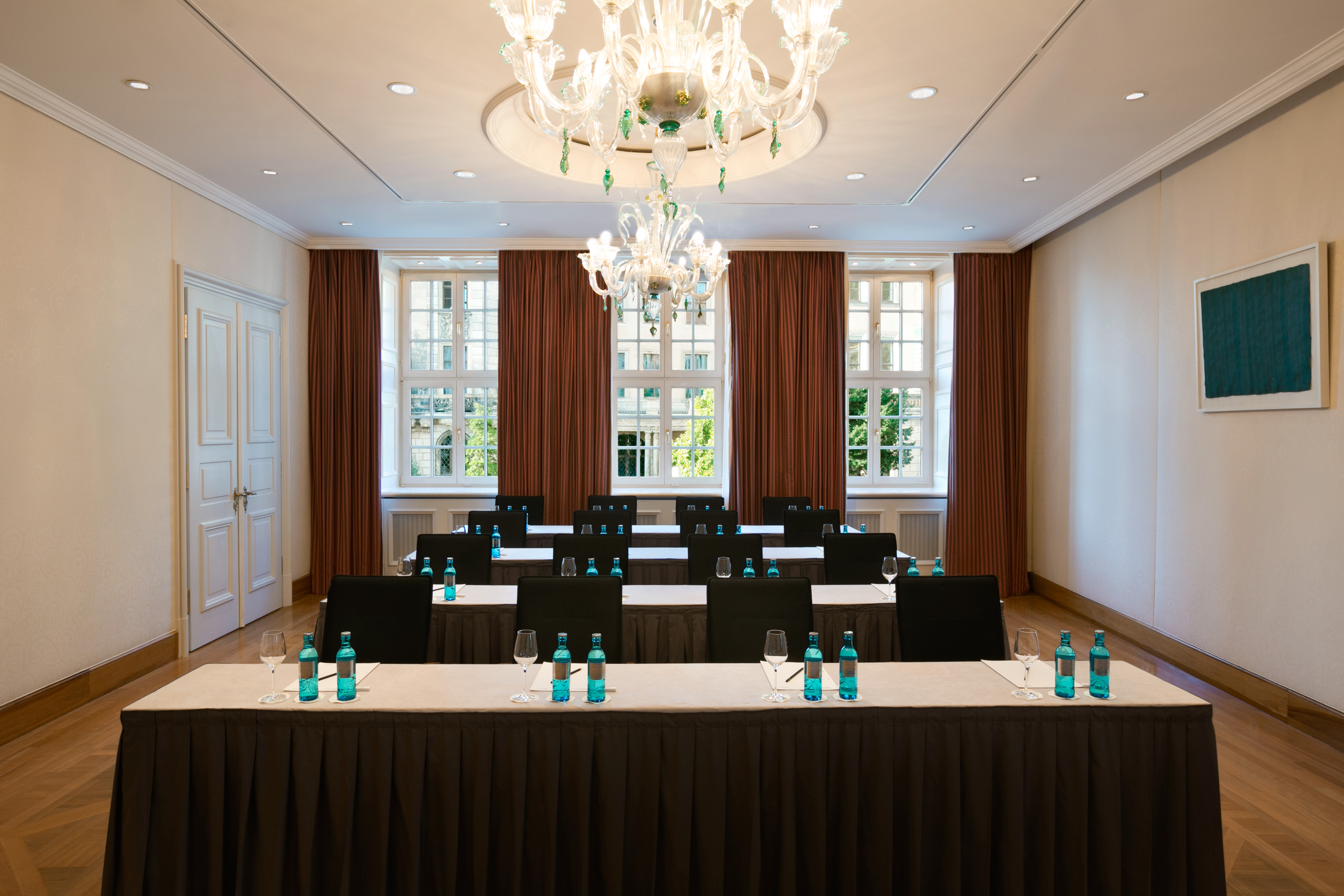 a room with tables and chairs and a chandelier