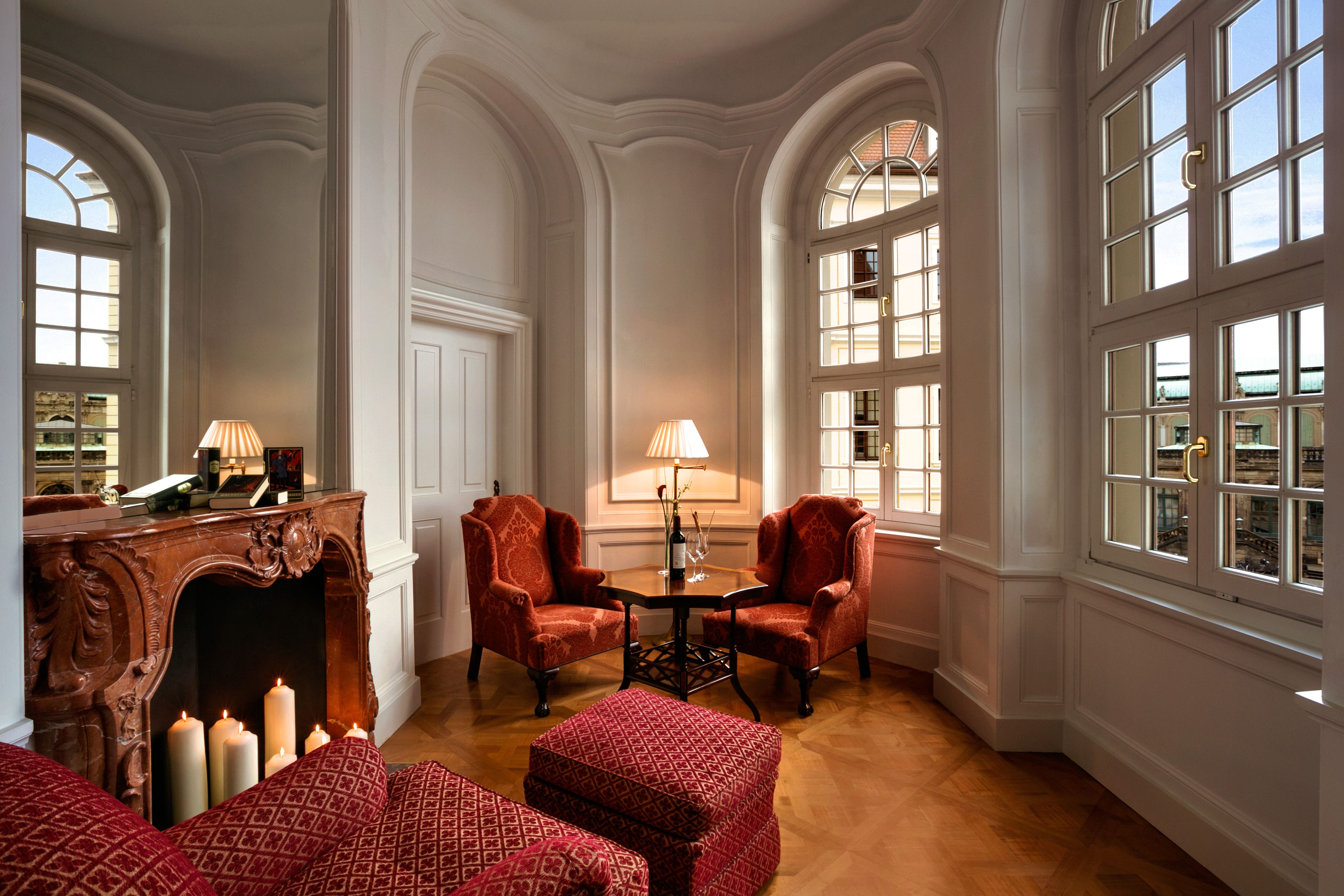 a room with red chairs and a table
