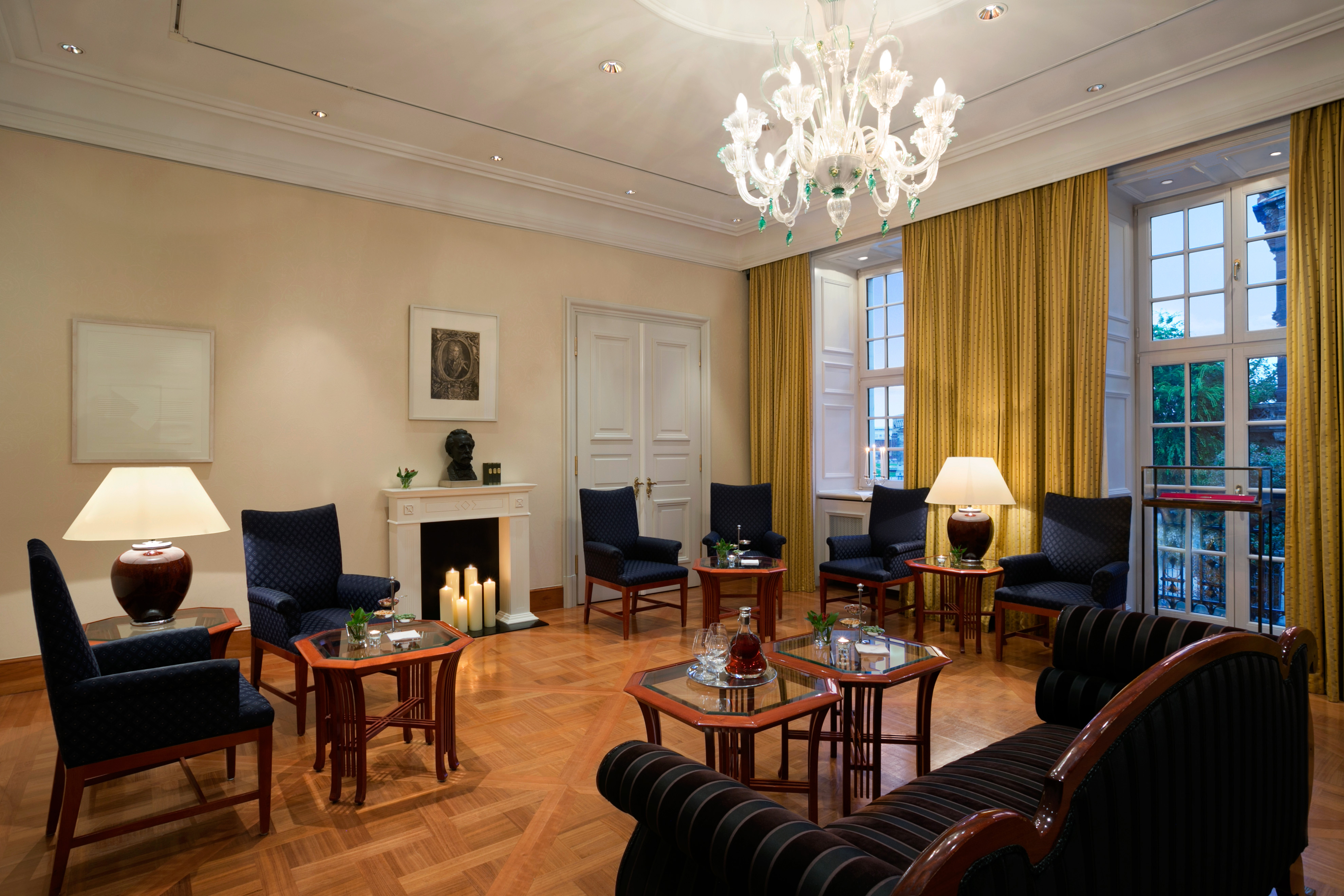 a room with a chandelier and chairs