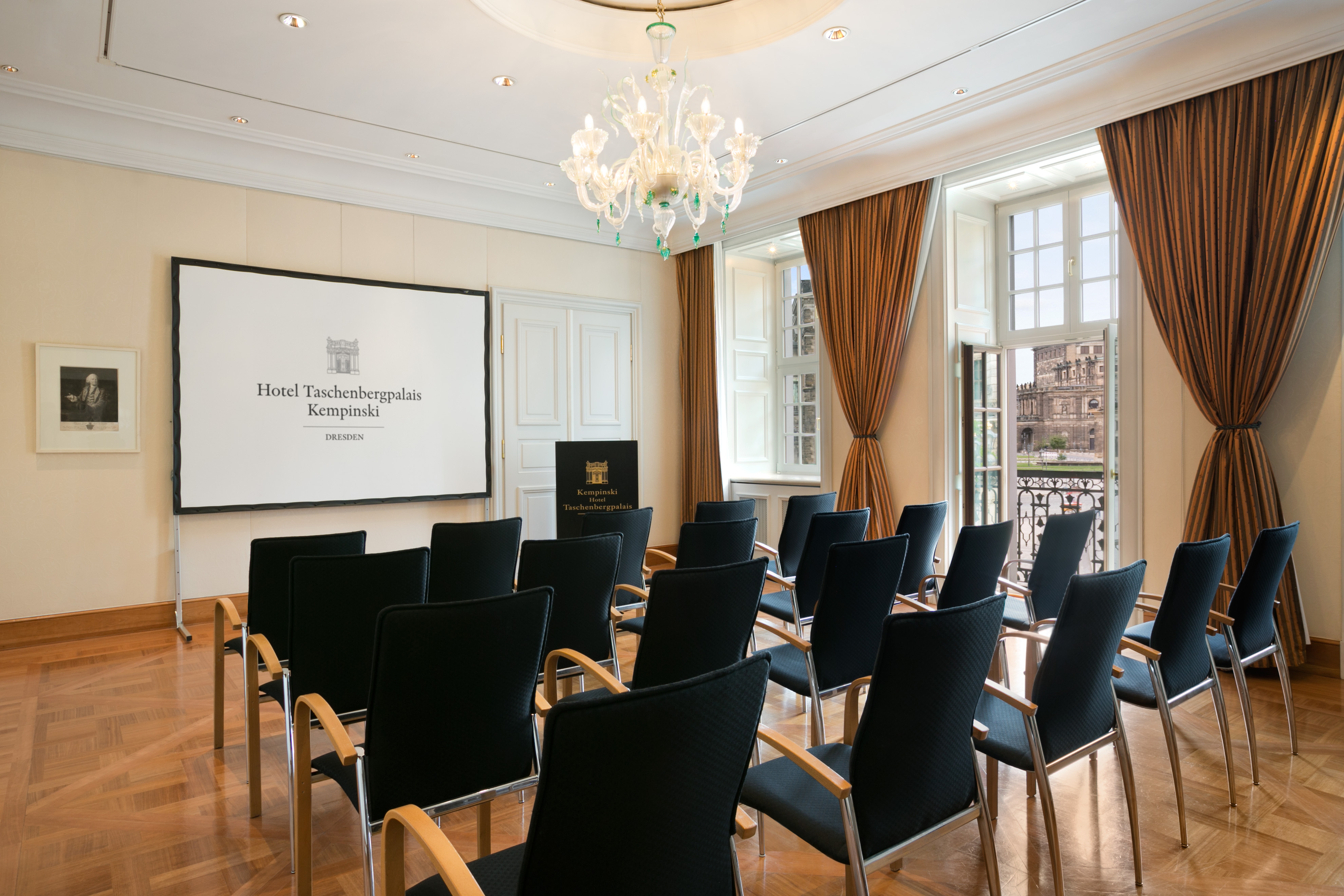 a room with chairs and a chandelier