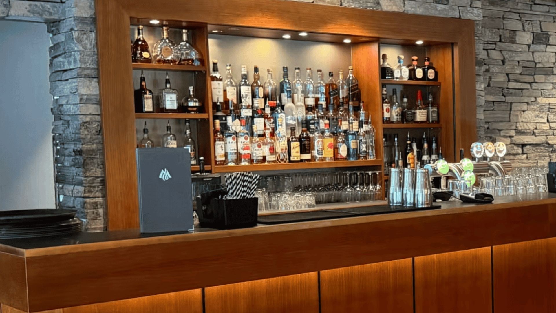 a bar with bottles and glasses
