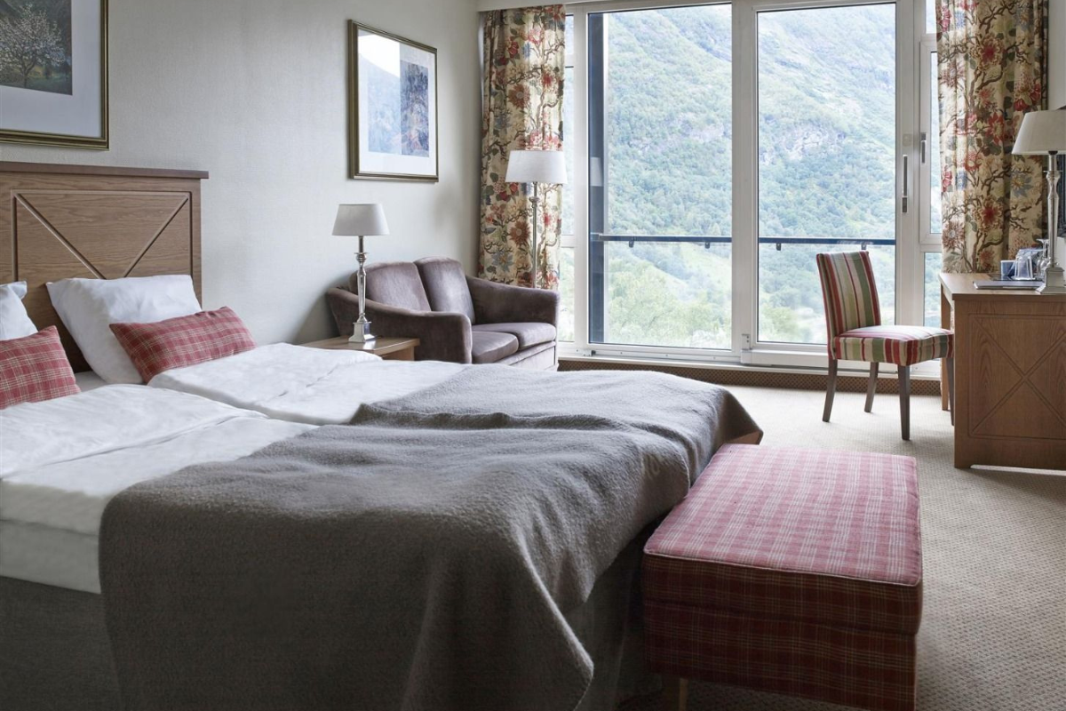 a bedroom with a bed and a chair