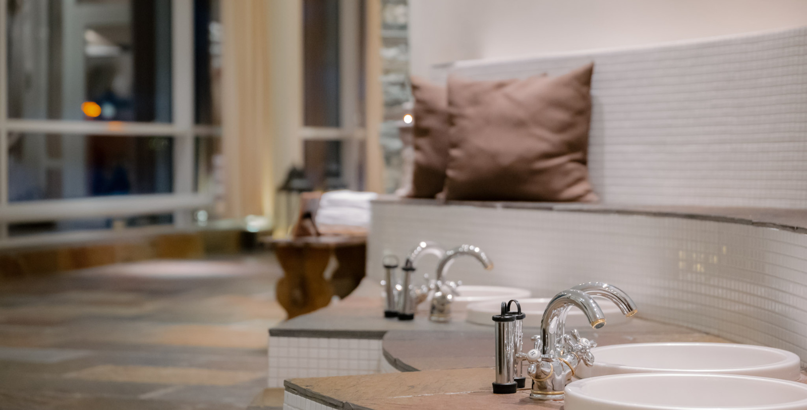 a bathroom with a sink and faucets