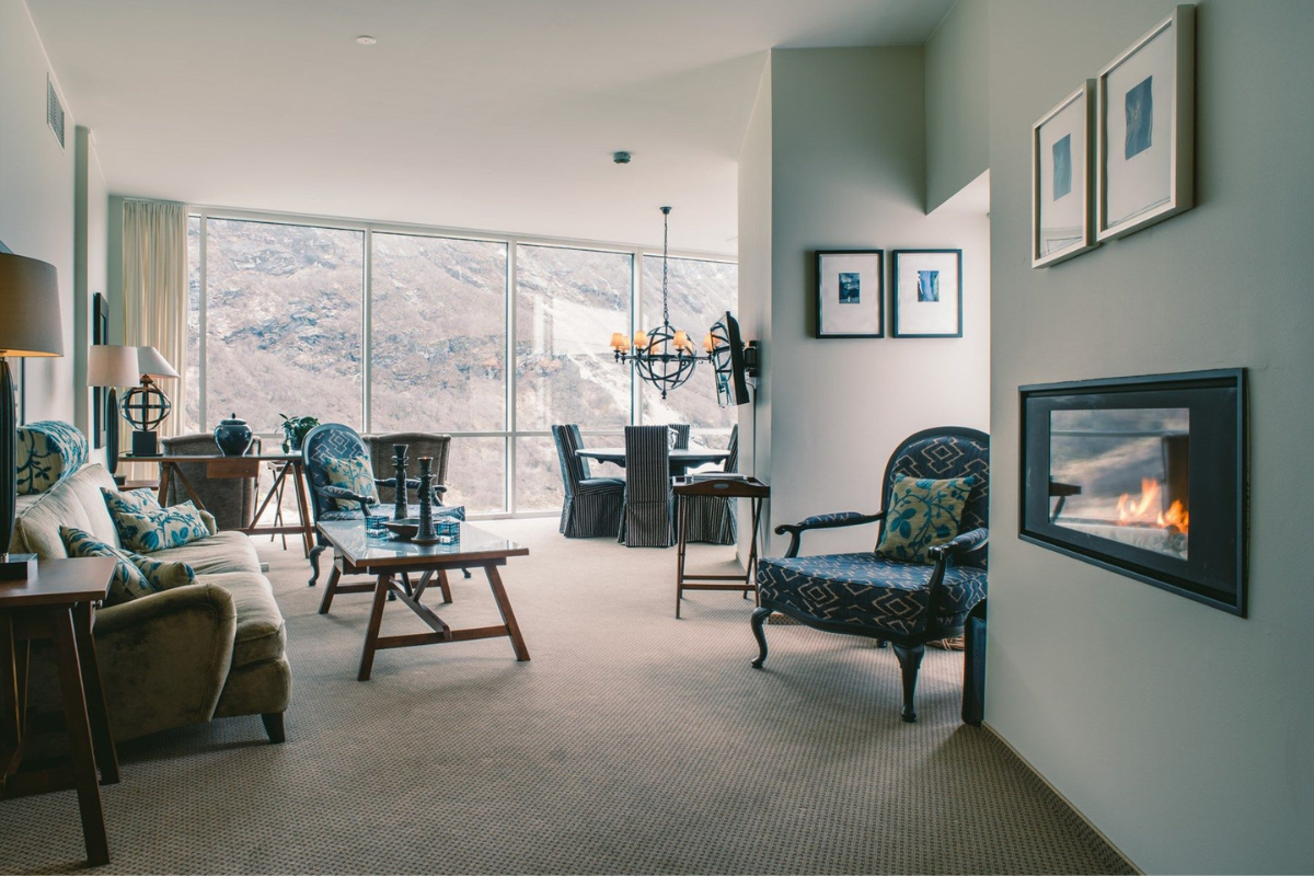 a living room with a fireplace and chairs
