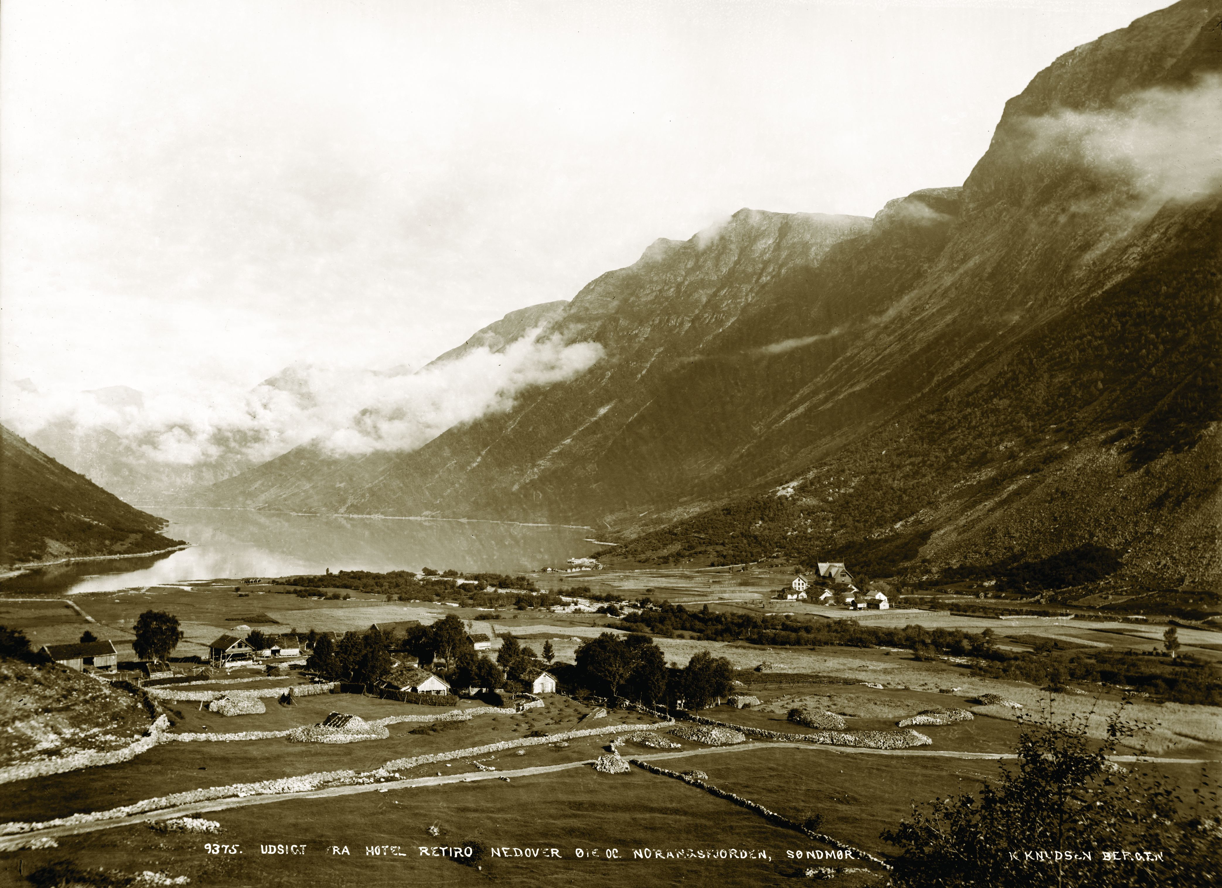 a landscape with a lake and mountains