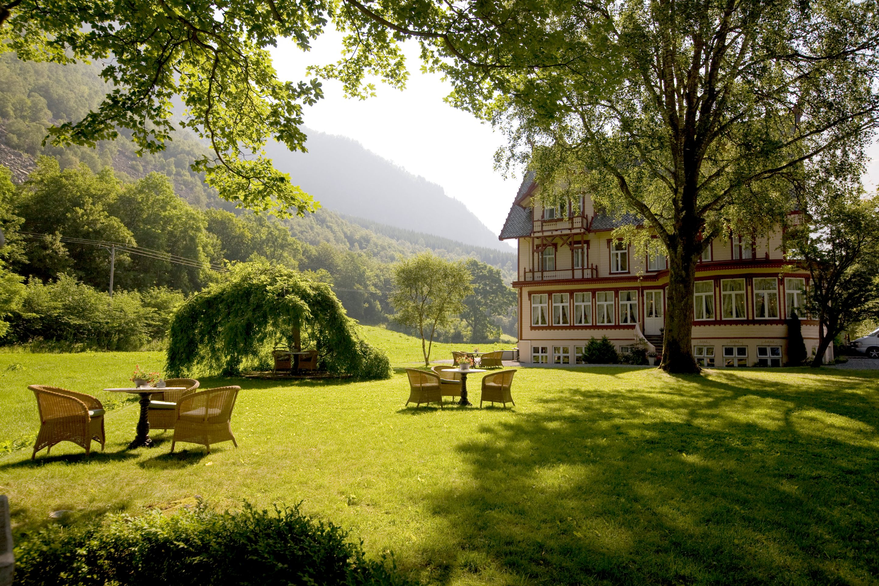 a house with a large lawn and chairs