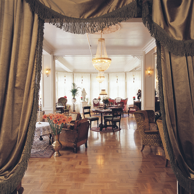 a room with a chandelier and a table