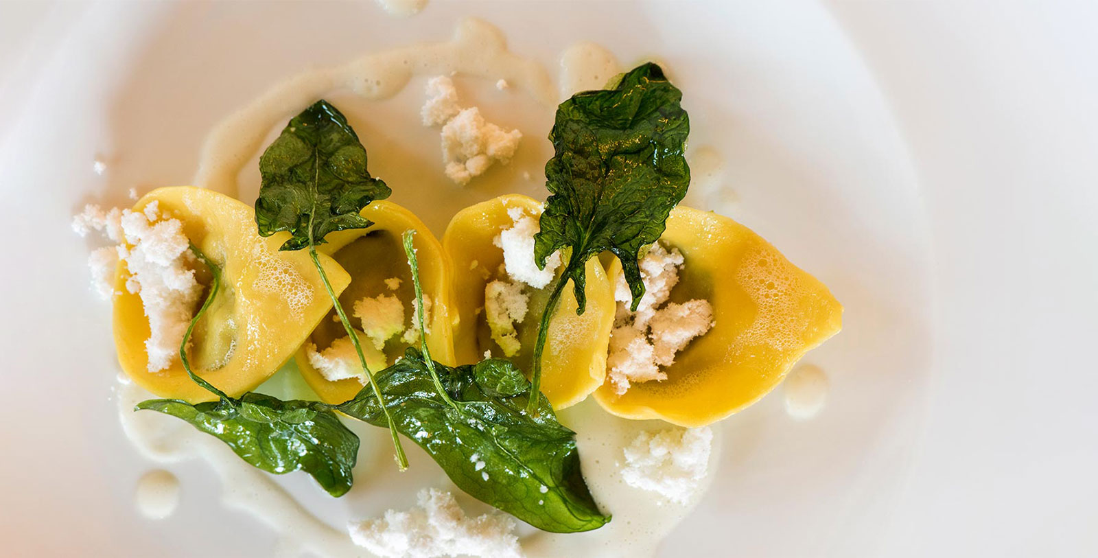 a plate of food with cheese and spinach