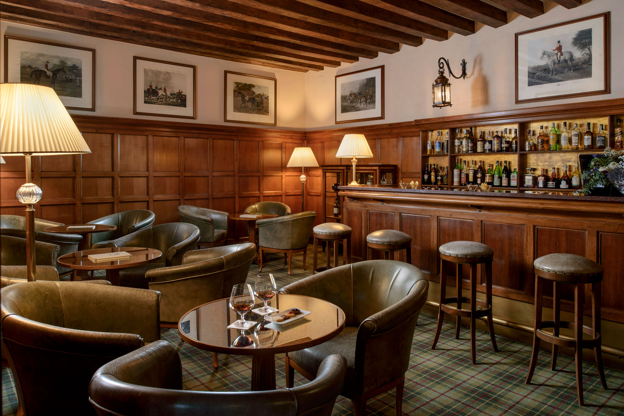 a room with a bar and tables and chairs