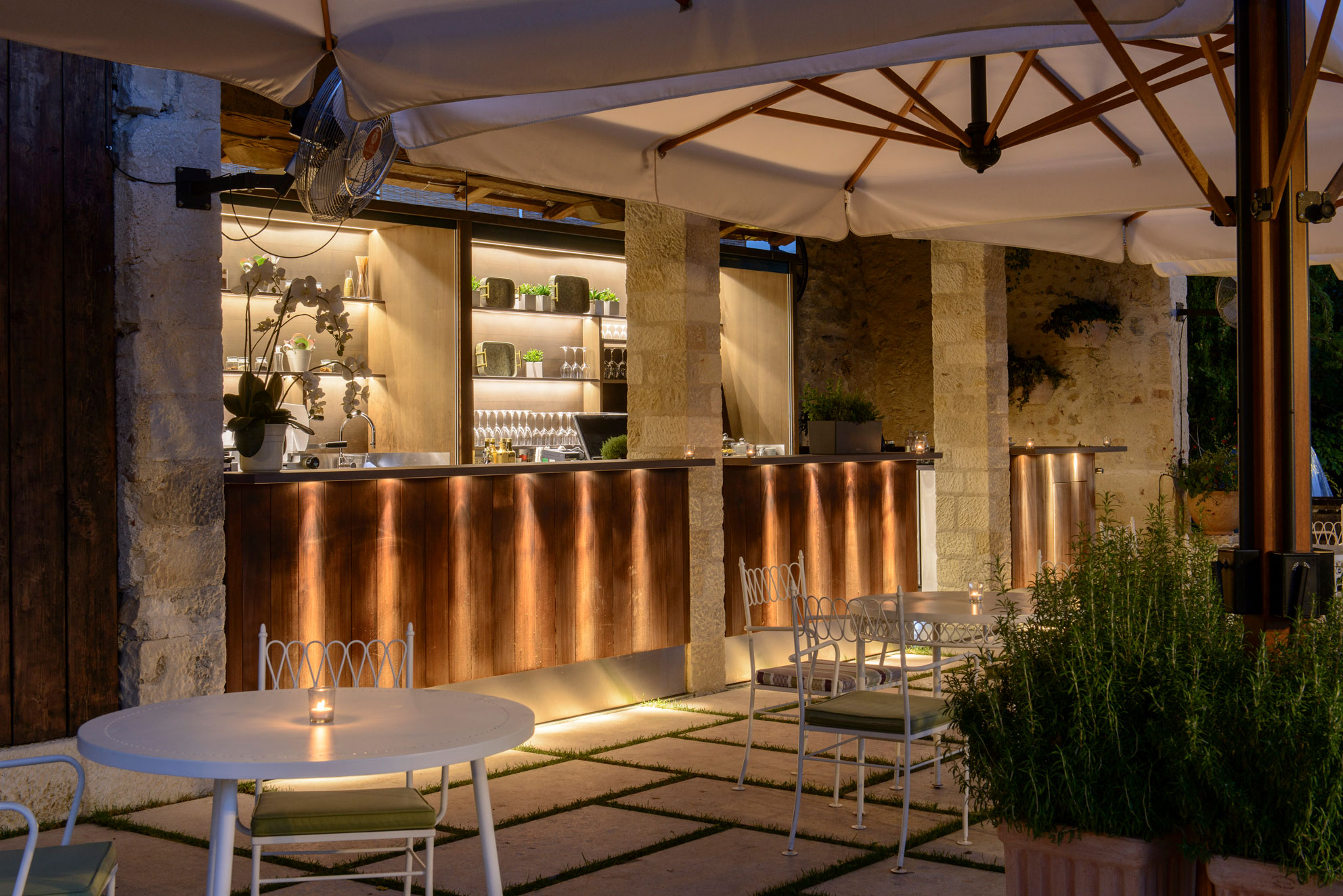 a outdoor bar with tables and chairs