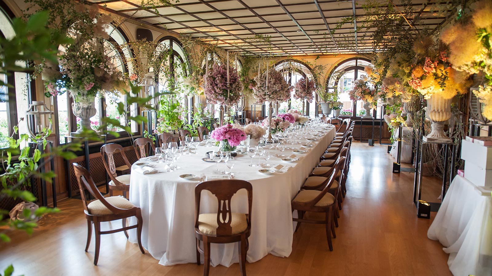 a long table with white tablecloths and flowers