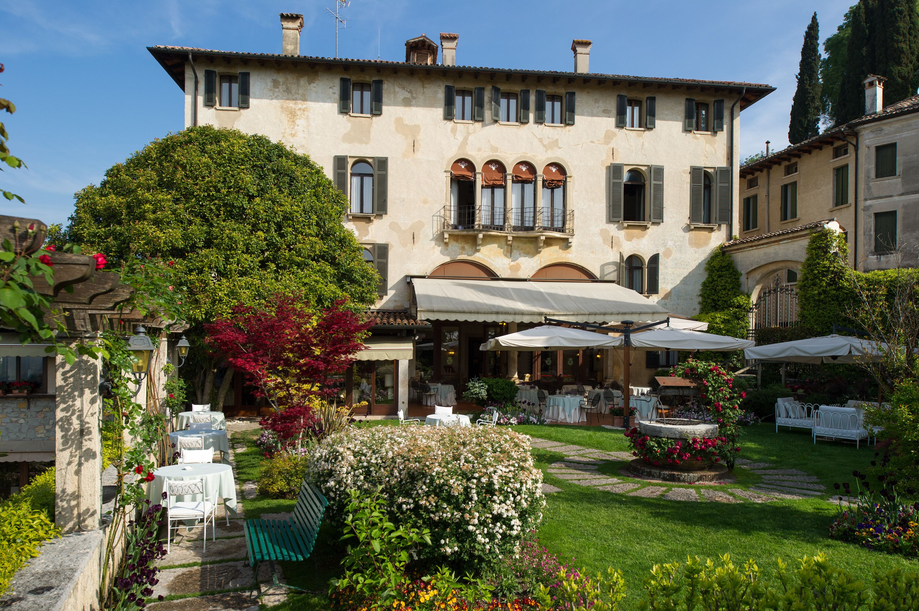 a building with a lawn and tables and chairs