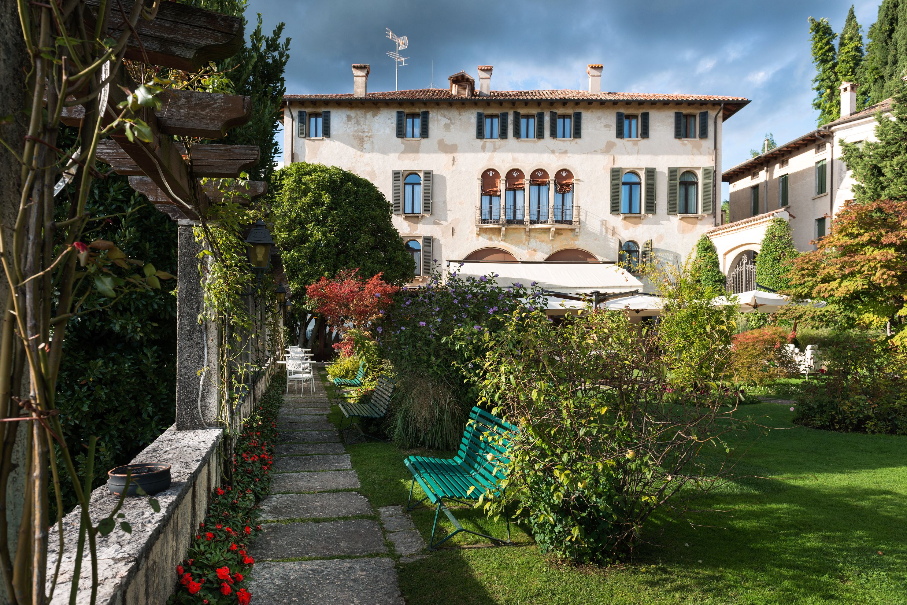 a building with a bench and a garden