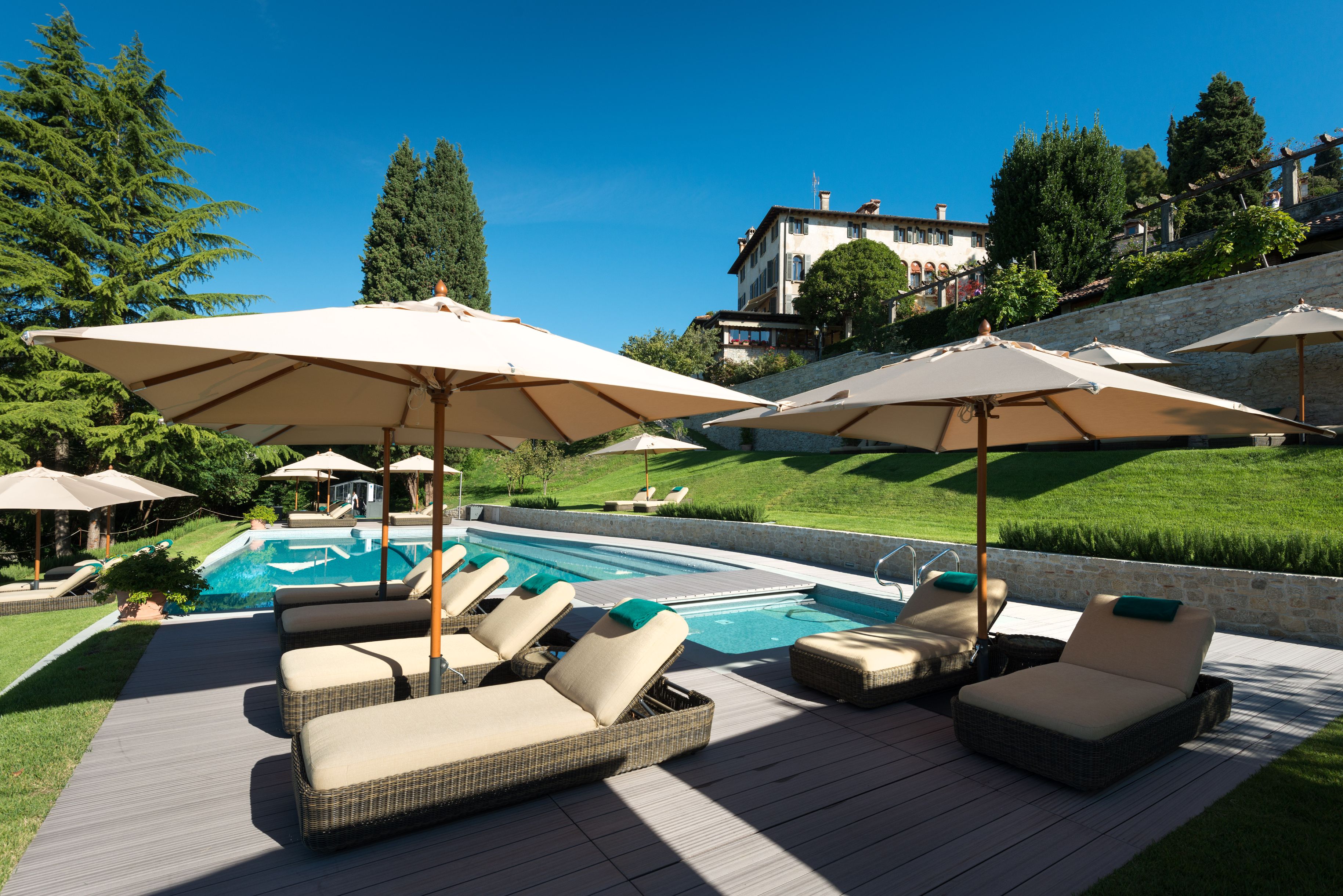 a pool with lounge chairs and umbrellas